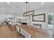 Open floor plan showcasing the kitchen island, modern lighting, and access to the dining area at 1972 Alcova Ridge Dr, Las Vegas, NV 89135