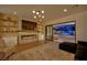 Cozy living room featuring a fireplace and sliding glass doors to the backyard at 1972 Alcova Ridge Dr, Las Vegas, NV 89135