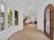 Bright entrance featuring hardwood flooring, an arched door and stairs at 1972 Alcova Ridge Dr, Las Vegas, NV 89135
