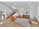 Open-concept living room has hardwood floors, recessed lighting, stylish furniture, and a staircase at 1972 Alcova Ridge Dr, Las Vegas, NV 89135