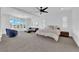 Spacious main bedroom with a seating area, ceiling fan and natural light at 1972 Alcova Ridge Dr, Las Vegas, NV 89135