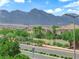 Scenic neighborhood view of homes, lush greenery, and the mountains in the background at 1972 Alcova Ridge Dr, Las Vegas, NV 89135