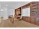 Home office with custom built-in wooden cabinets, drawers, desk, and hardwood floors at 1972 Alcova Ridge Dr, Las Vegas, NV 89135
