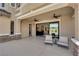 Covered patio with ceiling fans, outdoor seating, and large sliding glass doors to the interior at 1972 Alcova Ridge Dr, Las Vegas, NV 89135