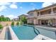 Beautiful backyard pool with an attached spa and patio seating at 1972 Alcova Ridge Dr, Las Vegas, NV 89135