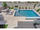 Beautiful pool and spa area with outdoor kitchen, lounge chairs, and well-manicured landscaping at 1972 Alcova Ridge Dr, Las Vegas, NV 89135