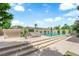 Beautiful pool and patio area with lounge chairs, mature trees, and landscaped surroundings at 1972 Alcova Ridge Dr, Las Vegas, NV 89135