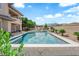 Backyard featuring a pool and spa, with a covered patio and lush landscaping at 1972 Alcova Ridge Dr, Las Vegas, NV 89135