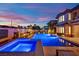 Stunning pool and spa with ambient lighting, surrounded by lush landscaping in a private backyard oasis at 1972 Alcova Ridge Dr, Las Vegas, NV 89135