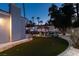 Beautiful backyard with a putting green and a gazebo surrounded by palm trees at 2101 Diamond Bar Dr, Las Vegas, NV 89117