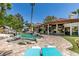 Spacious backyard featuring a large pool, rock waterfall, and an expansive tiled patio at 2101 Diamond Bar Dr, Las Vegas, NV 89117