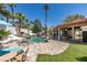 Inviting backyard with large pool, rock waterfall, green grass, and covered patio area at 2101 Diamond Bar Dr, Las Vegas, NV 89117