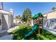 Playful backyard featuring a swing set, slide, and a manicured lawn with a putting green at 2101 Diamond Bar Dr, Las Vegas, NV 89117