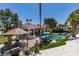 This backyard features a pristine pool, an outdoor kitchen, and relaxing seating areas, perfect for entertaining guests at 2101 Diamond Bar Dr, Las Vegas, NV 89117