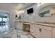 Bathroom featuring granite countertops, white cabinets, dual sinks, and a wall-mounted television at 2101 Diamond Bar Dr, Las Vegas, NV 89117