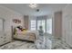 Bright bedroom with large windows, marble floors, a vanity table, and a cozy bed at 2101 Diamond Bar Dr, Las Vegas, NV 89117