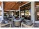 Comfortable covered patio with outdoor seating, ceiling fans, and stone fire table offers relaxation and entertainment space at 2101 Diamond Bar Dr, Las Vegas, NV 89117