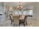 Elegant dining area with chandelier and views of the lush backyard at 2101 Diamond Bar Dr, Las Vegas, NV 89117