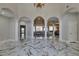 Grand foyer featuring soaring ceilings, marble floors, and an open floor plan with decorative columns and arches at 2101 Diamond Bar Dr, Las Vegas, NV 89117