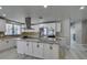 Modern kitchen with white cabinets, stainless steel appliances, and a center island with granite countertops at 2101 Diamond Bar Dr, Las Vegas, NV 89117