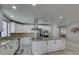 Bright kitchen boasts white cabinets, stainless steel appliances, and a large center island with granite countertops at 2101 Diamond Bar Dr, Las Vegas, NV 89117