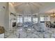 Open-concept living area featuring marble floors, a fireplace, and large windows, perfect for entertaining guests at 2101 Diamond Bar Dr, Las Vegas, NV 89117