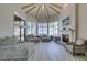 Bright living room with vaulted ceilings, fireplace, and views of the pool and outdoor living area at 2101 Diamond Bar Dr, Las Vegas, NV 89117