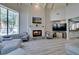 Comfortable living room with fireplace, vaulted ceiling, and seamless flow into the kitchen area at 2101 Diamond Bar Dr, Las Vegas, NV 89117