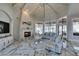 Bright living room with a fireplace, white wood ceilings, marble flooring, and large windows with outdoor views at 2101 Diamond Bar Dr, Las Vegas, NV 89117