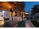 Relaxing outdoor living space at night with comfortable seating area, TV, and tropical landscaping create an inviting ambiance at 2101 Diamond Bar Dr, Las Vegas, NV 89117