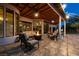 Covered patio with tiled flooring, comfortable seating, and a cozy fire pit at 2101 Diamond Bar Dr, Las Vegas, NV 89117