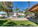 Backyard oasis with sparkling pool, waterfall feature, lush landscaping and ample seating at 2101 Diamond Bar Dr, Las Vegas, NV 89117