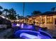 Gorgeous pool with a spa and waterfalls, surrounded by lush landscaping and a covered patio at 2101 Diamond Bar Dr, Las Vegas, NV 89117