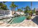Backyard pool with a cascading waterfall feature, hot tub, and lush tropical landscaping at 2101 Diamond Bar Dr, Las Vegas, NV 89117