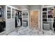 Custom walk-in closet with built-in shelves and marble flooring at 2101 Diamond Bar Dr, Las Vegas, NV 89117