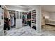 Organized walk-in closet with hanging rods, shelving and marble floors at 2101 Diamond Bar Dr, Las Vegas, NV 89117