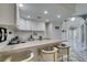 Modern wet bar with granite countertop, white cabinets, and stylish seating at 2101 Diamond Bar Dr, Las Vegas, NV 89117