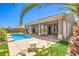 An outdoor pool and patio area features manicured lawn and mature landscaping at 2158 High Mesa Dr, Henderson, NV 89012