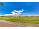 A well-manicured green golf course with distant houses on a bright, sunny day at 2158 High Mesa Dr, Henderson, NV 89012