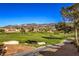 Expansive view of the golf course and surrounding neighborhood set against a mountain backdrop at 2158 High Mesa Dr, Henderson, NV 89012