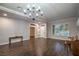Spacious living room featuring hardwood floors, plantation shutters, and decorative chandelier at 2158 High Mesa Dr, Henderson, NV 89012