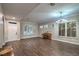 Spacious living room featuring hardwood floors, plantation shutters, and decorative chandelier at 2158 High Mesa Dr, Henderson, NV 89012