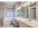 Well-lit main bathroom with double sinks, separate shower, and soaking tub at 2158 High Mesa Dr, Henderson, NV 89012