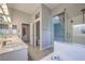 Main bathroom with double sinks, glass shower and access to the main bedroom at 2158 High Mesa Dr, Henderson, NV 89012