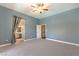 Main bedroom with neutral carpet, ceiling fan and bathroom entrance at 2158 High Mesa Dr, Henderson, NV 89012