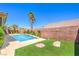 An outdoor pool and patio area with mature trees, and lawn at 2158 High Mesa Dr, Henderson, NV 89012