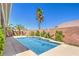 Captivating backyard pool area with a tall palm tree for privacy and shade on a sunny day at 2158 High Mesa Dr, Henderson, NV 89012