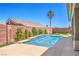A beautiful backyard pool area with mature landscaping and a brick perimeter wall at 2158 High Mesa Dr, Henderson, NV 89012