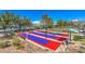 An overview of outdoor shuffleboard courts with benches and seating areas under a clear sky at 2158 High Mesa Dr, Henderson, NV 89012