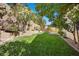 A beautiful backyard featuring lush green grass and manicured landscaping offers a private outdoor retreat at 2329 Sunrise Meadows Dr, Las Vegas, NV 89134
